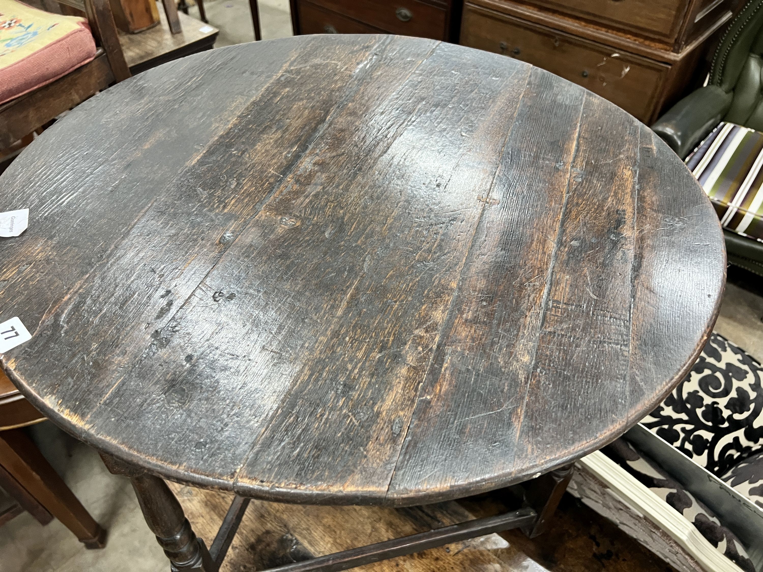 An 18th century circular oak cricket table, diameter 70cm, height 67cm